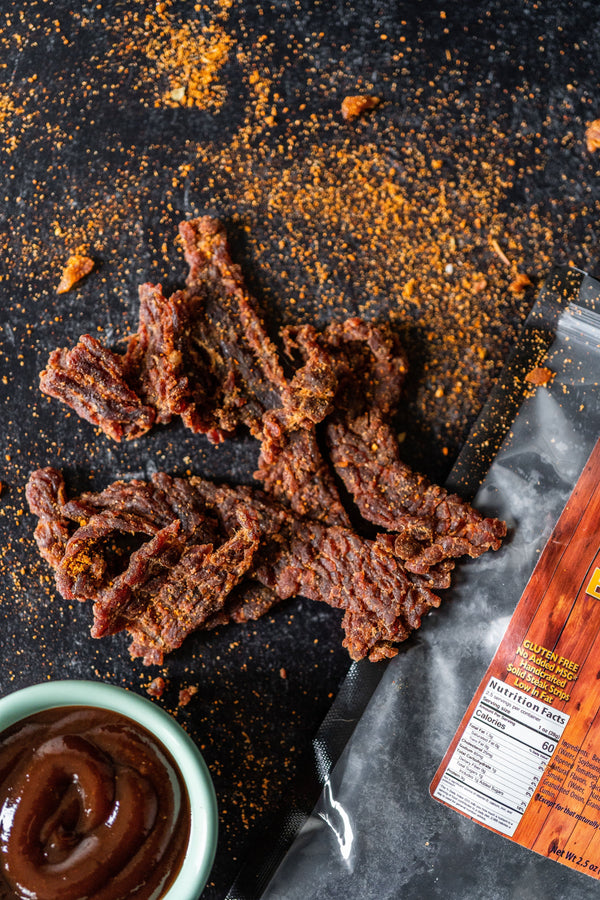 Photo of Bristet Beef Jery smothered in seasonings and BBQ dip on the side.